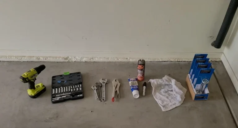Garage door repair tools including wrenches and drill