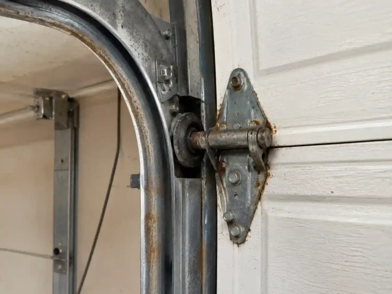 Garage door track and hardware showing rust wear from Tallahassee humidity